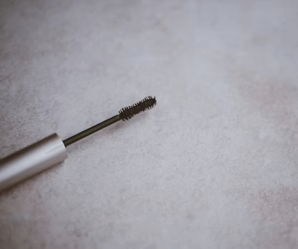 Close-up of mascara tube on white background
