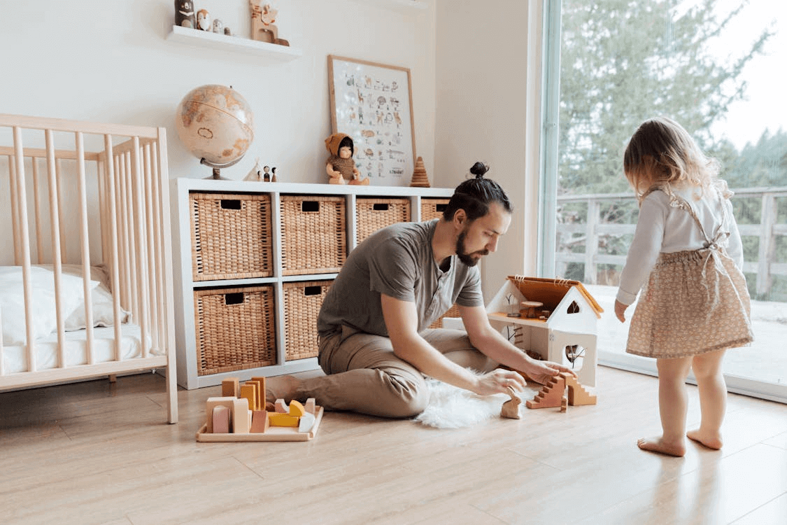 Young girl playing with a doll in a family room