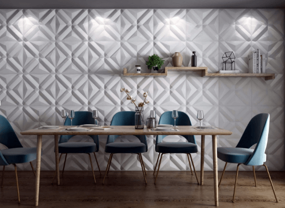 Modern dining room with geometric wall panels, blue chairs, and a table setting
