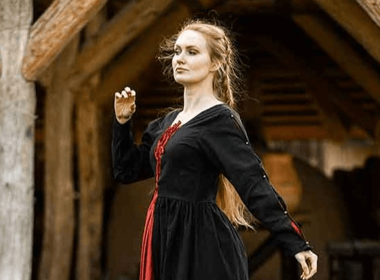Woman in a gothic black dress outdoors