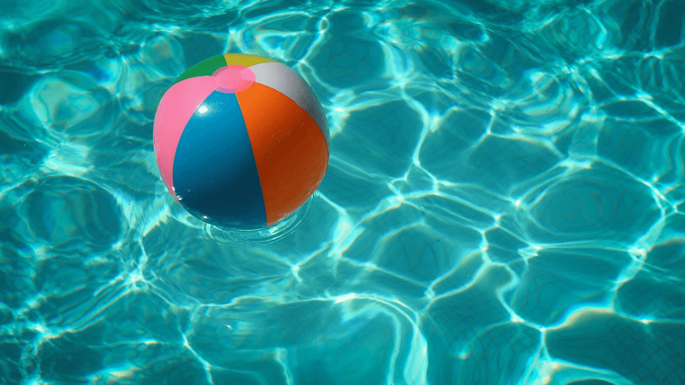 Beach ball floating in a clean, clear pool