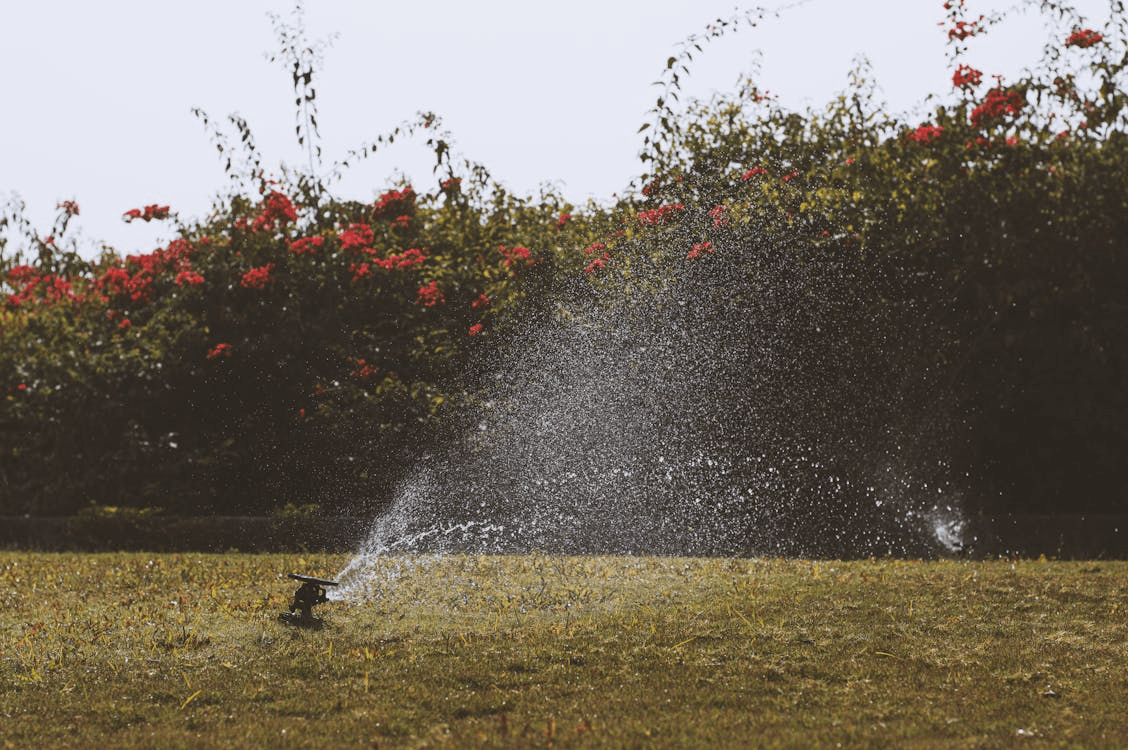 Fire hydrant spewing water wildly on a