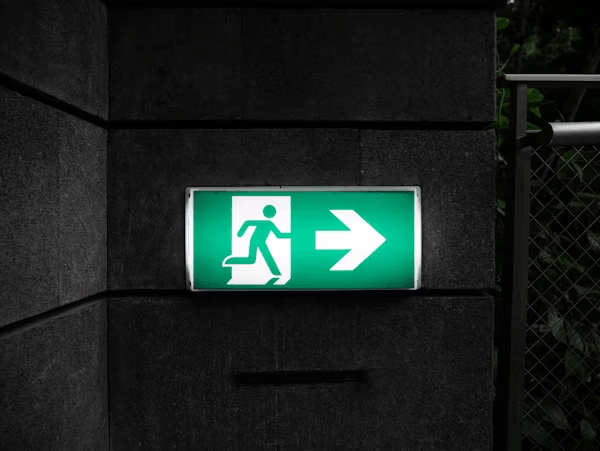 Green sign with left arrow indicating direction