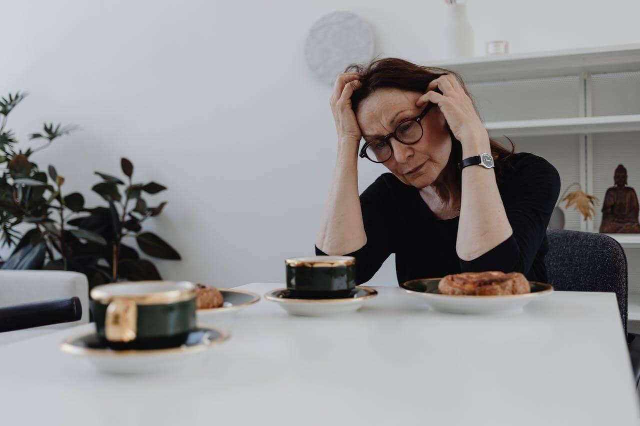 A woman sitting at a table with a plate of