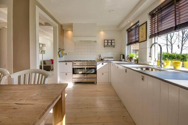 Kitchen with wooden table and white cabinets