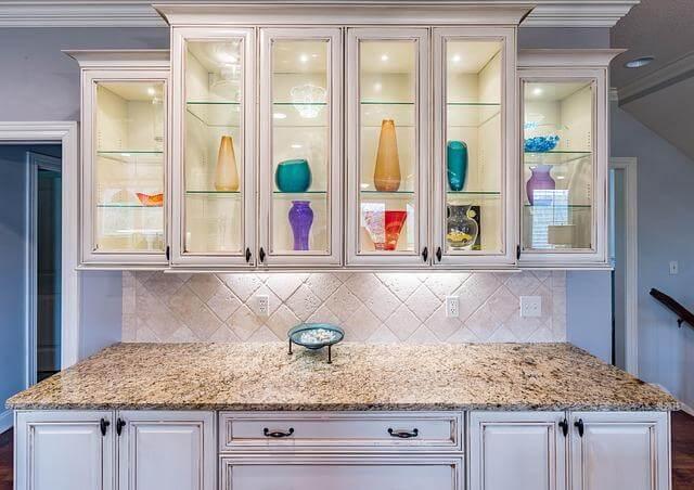 Modern kitchen with white cabinets and marble countertops from Hayden