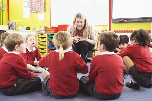 Woman modeling communication skills to children