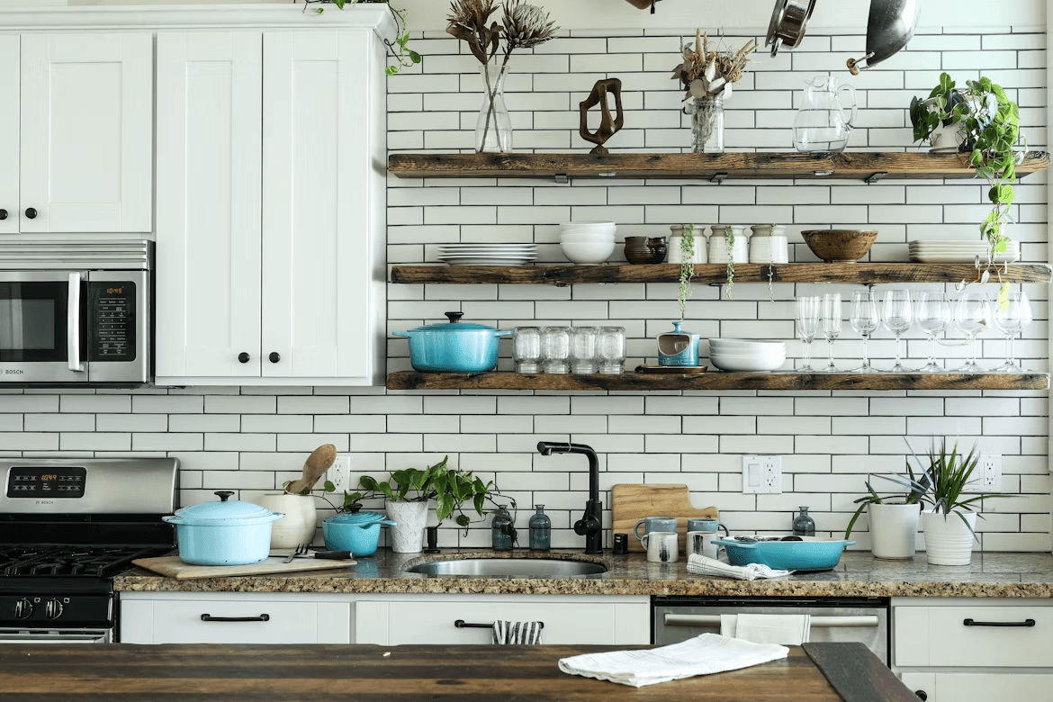 A modern kitchen with many white cabinets