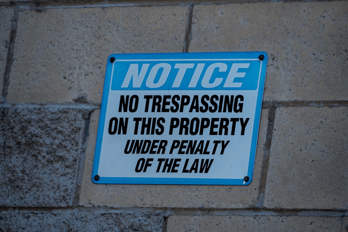 Blue and white sign on a brick wall