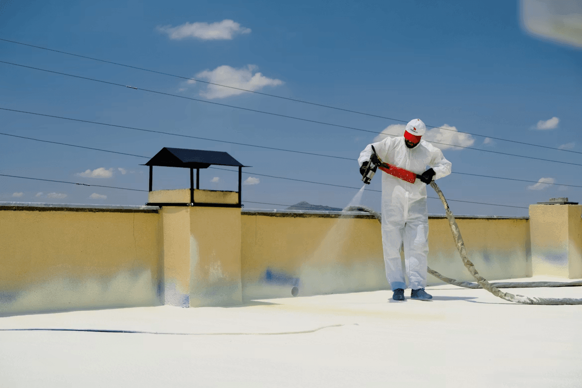 Man applying epoxy coating to a concrete roof
