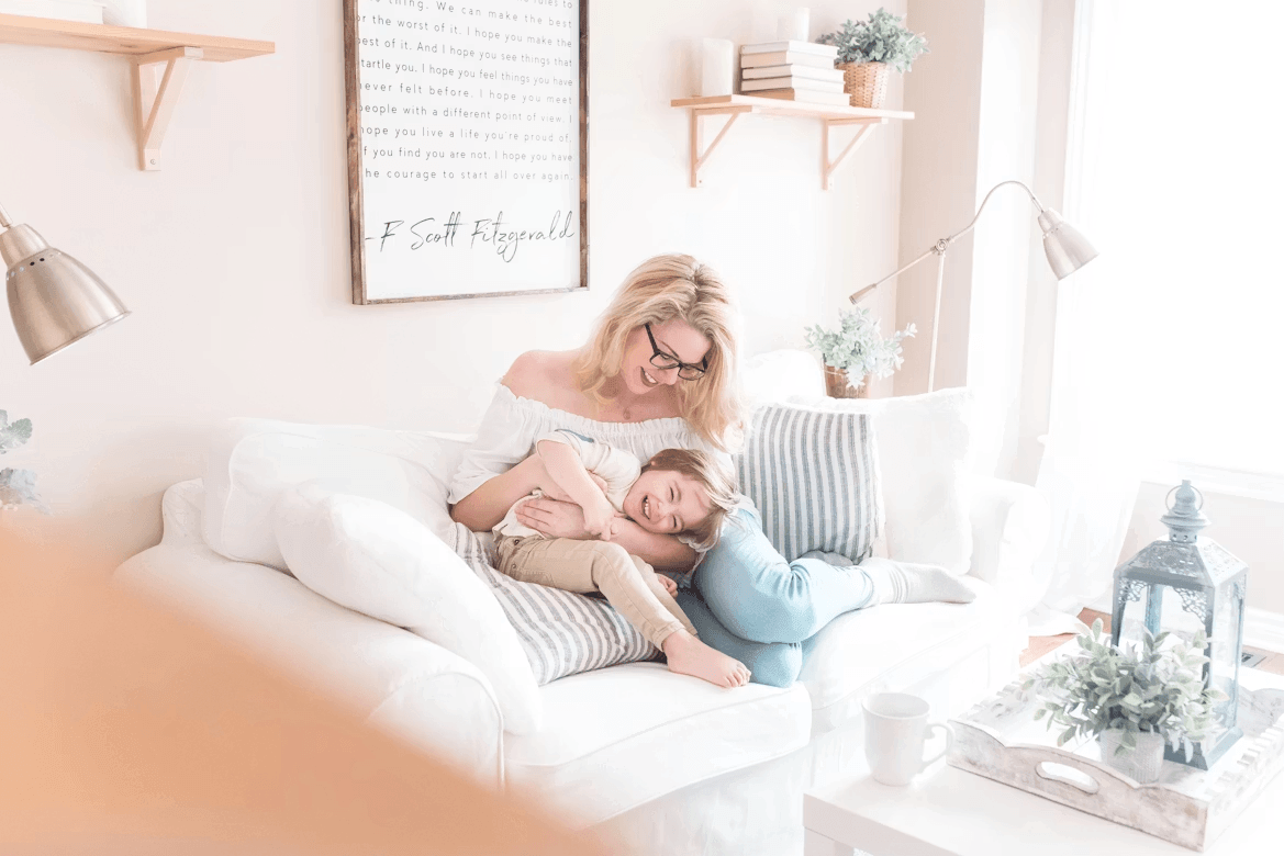 Mommy blogger with child cuddling on a couch