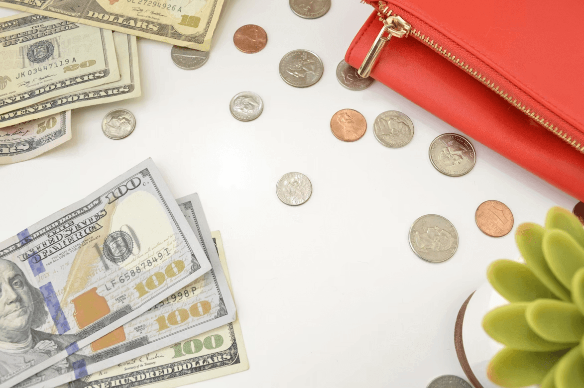Red purse and money on a table