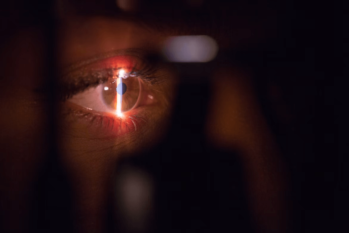 Close-up of an eye looking through a magnifying