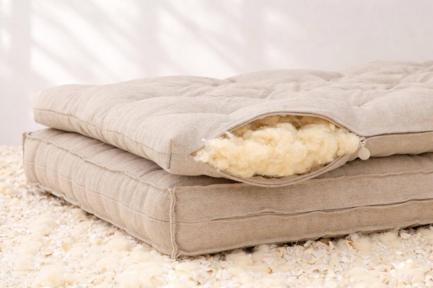 Comfortable mattress resting on a pile of sand,