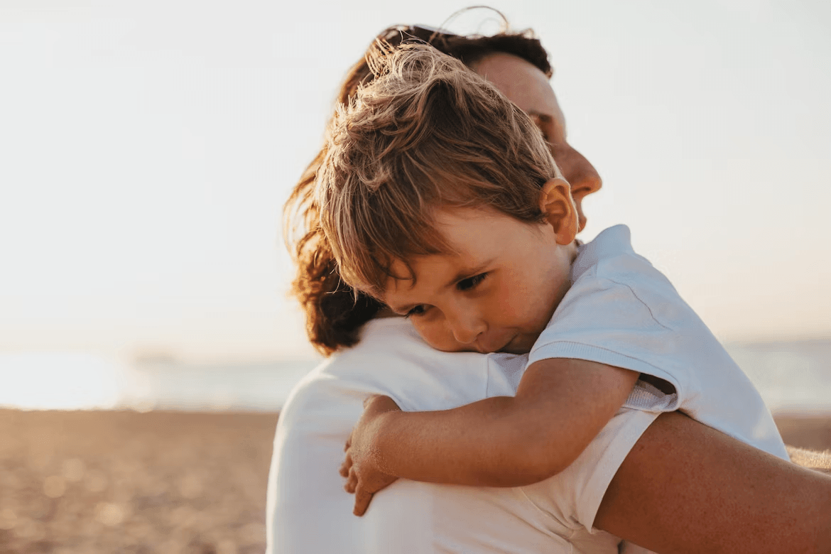 Father holding child on beach, a moment of