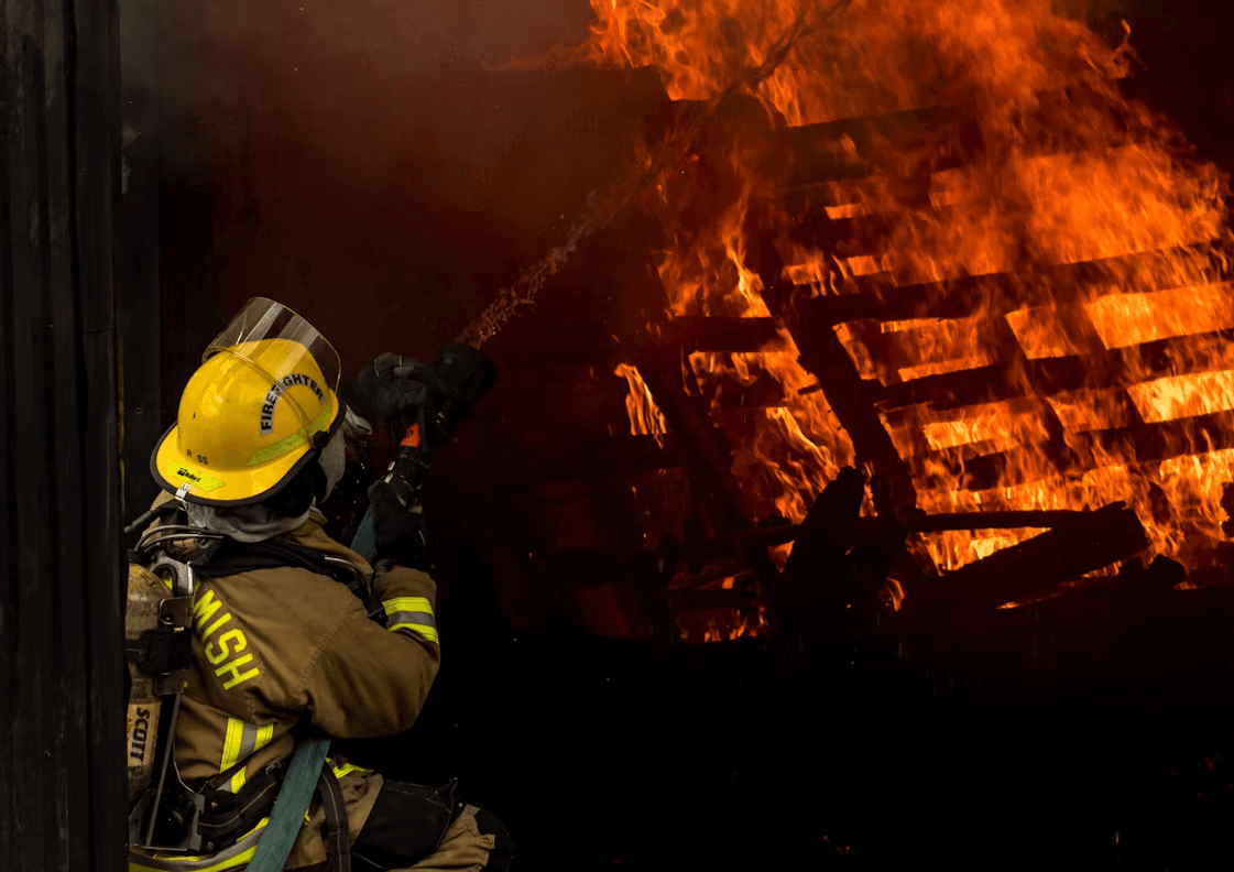 Firefighter in protective gear in front