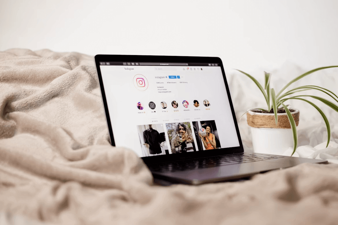 Laptop on a bed, illustrating remote or flexible