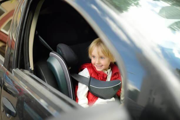 Little girl safely seated in a car seat