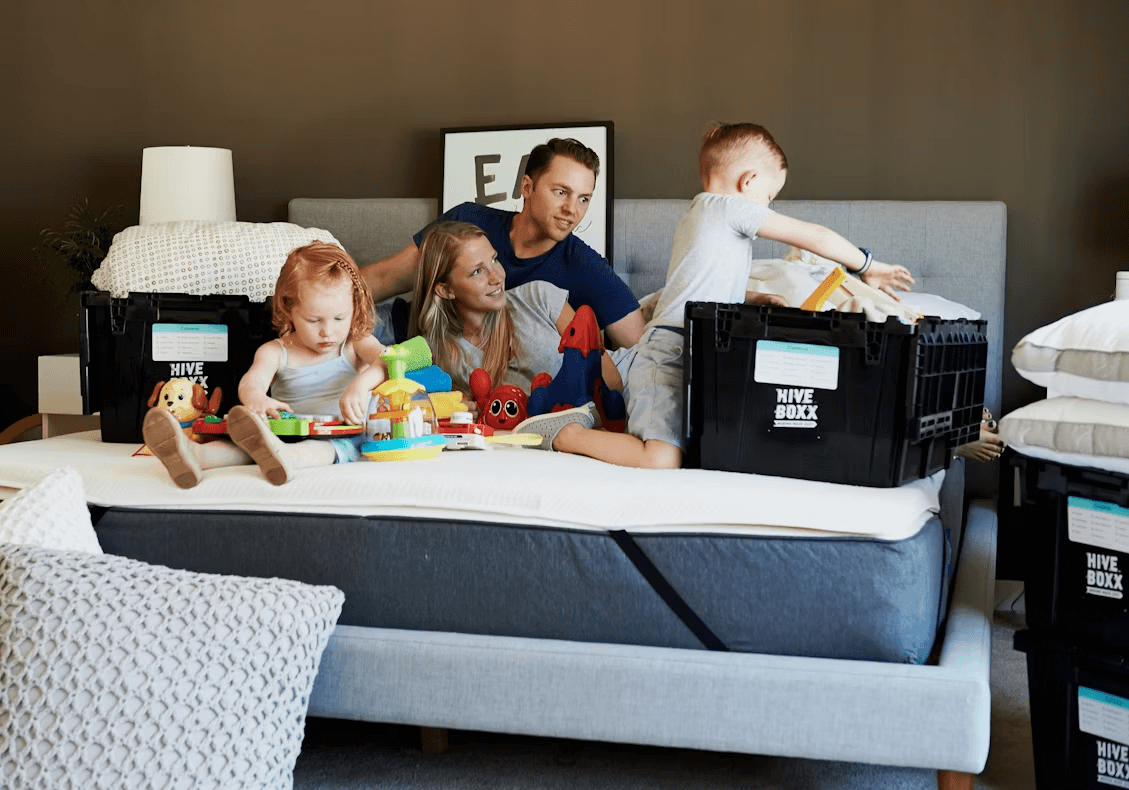 Man and two children happily playing with toys on a