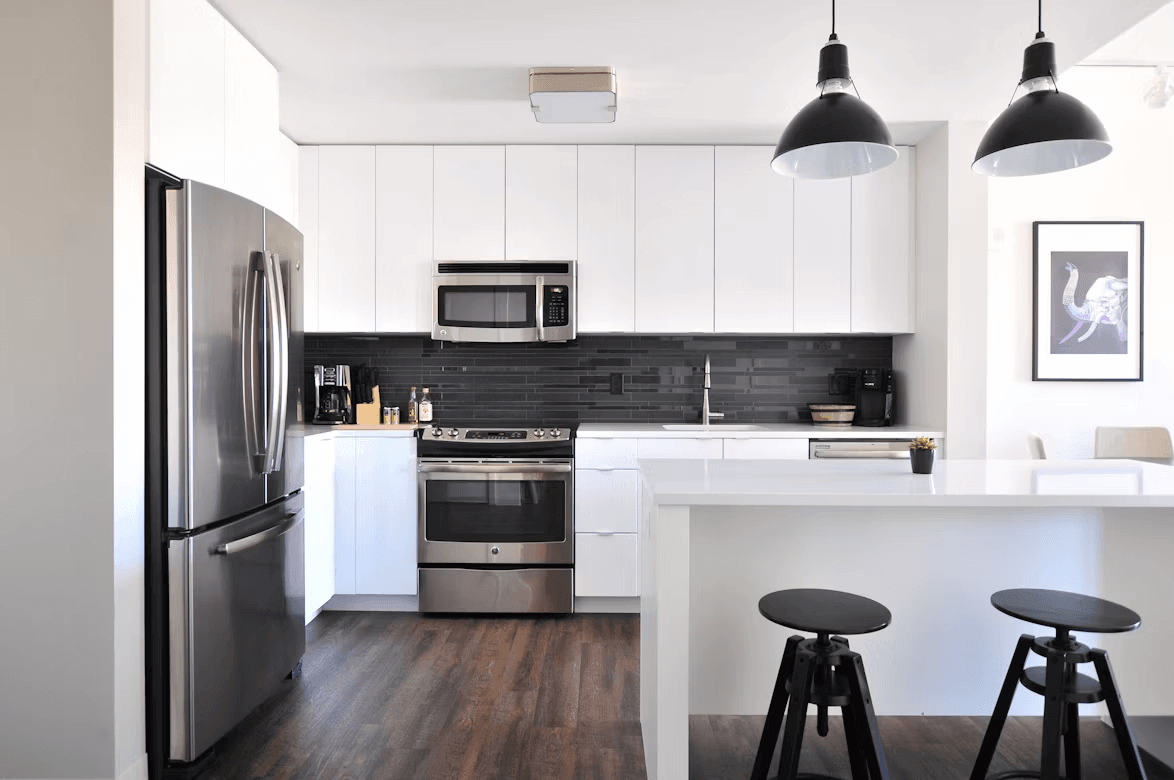 Modern kitchen with stove, refrigerator, and two