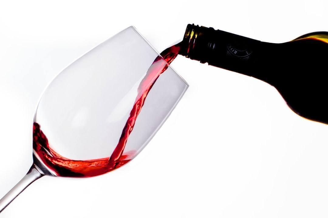 Red wine being poured for a tasting party