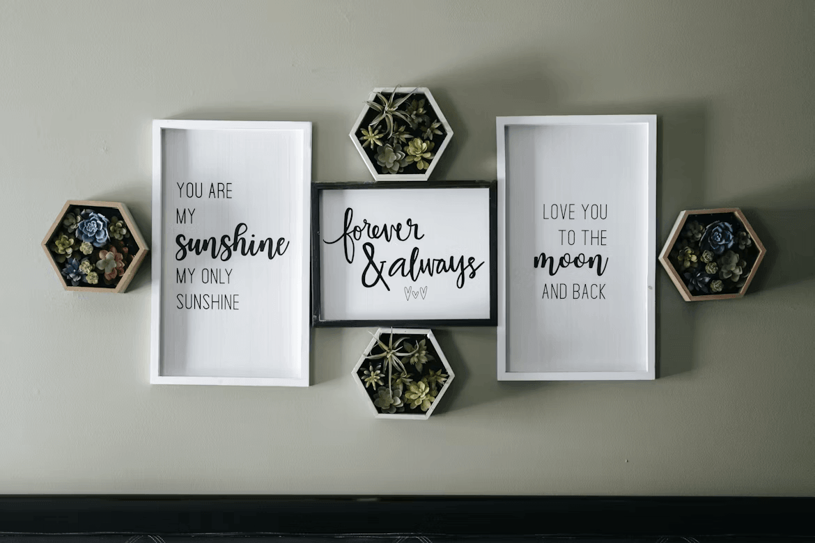 Three framed printable wall art pieces on a wall