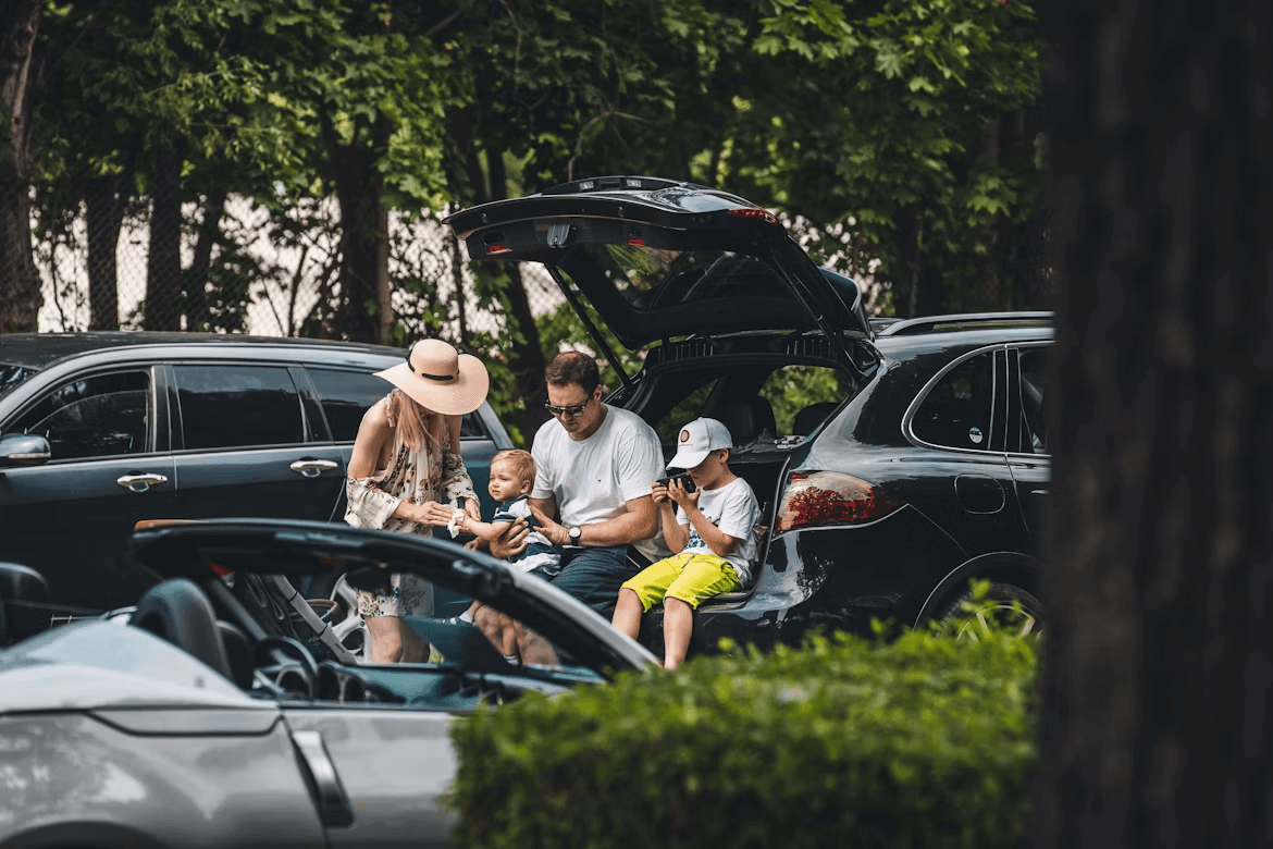 Family members squeezed into car trunk looking for space
