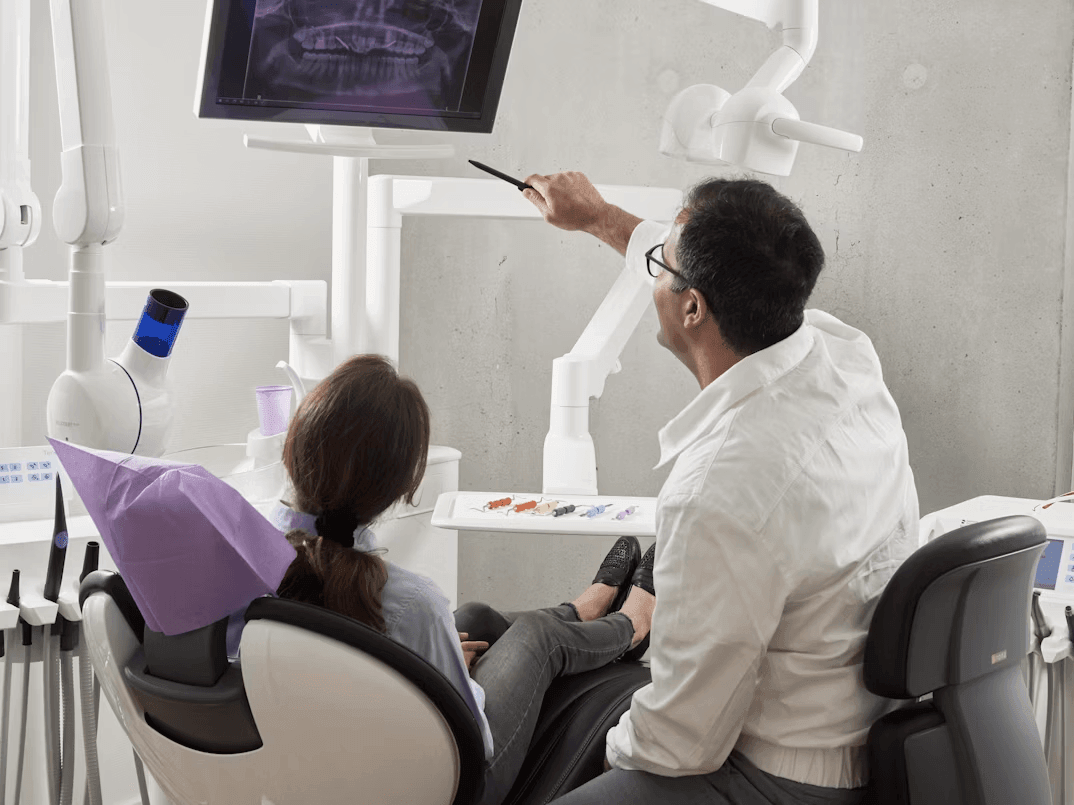 Father and daughter review dental insurance benefits on a