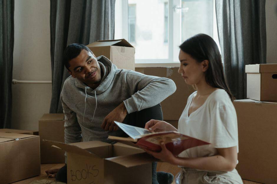 Man and woman unpacking boxes after moving day