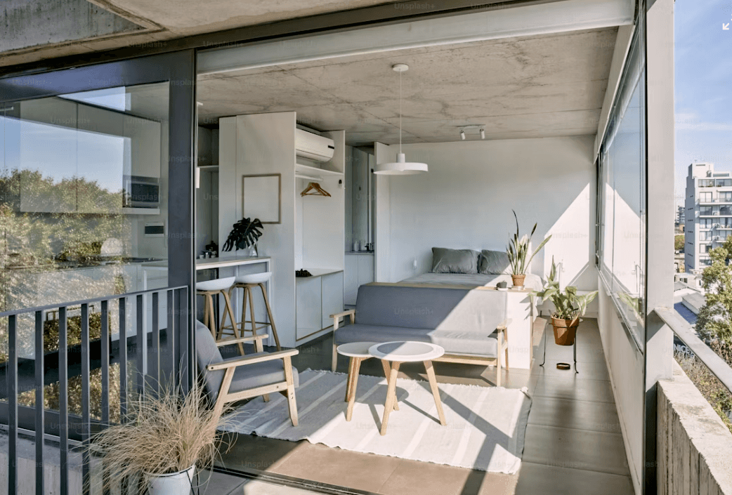 Modern condo balcony with table, chairs, and