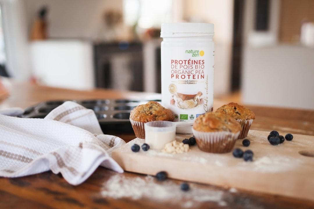 Collagen and protein powder tubs on a bright modern kitchen counter