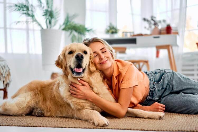 Woman laying on the floor with her dog,