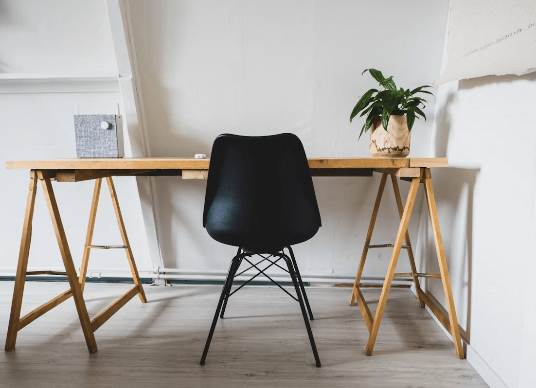 Black chair next to a wooden desk