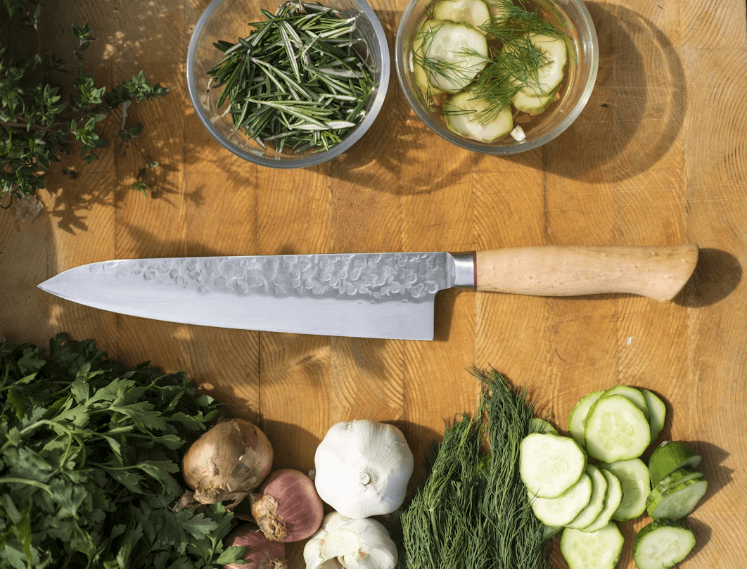 Kitchen knife and vegetables on a table for