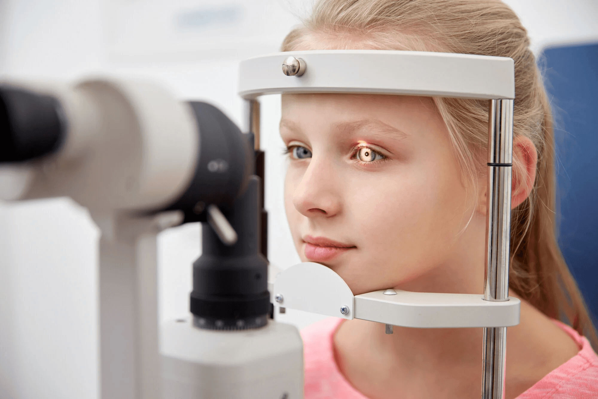 Young girl looking through a microscope, symbolizing